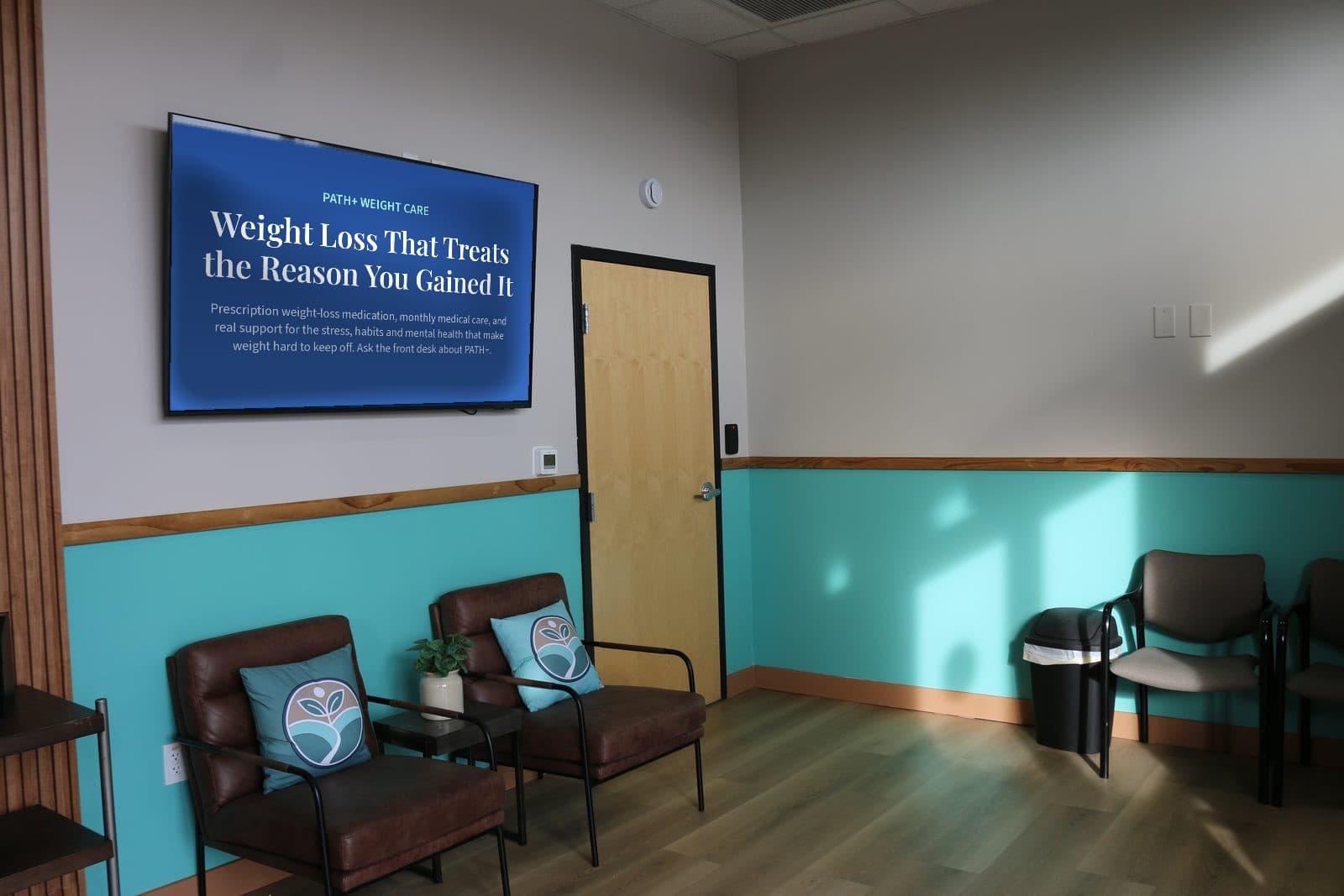 The PATH Health Services waiting room in Tempe: leather armchairs, a plant, and a screen on the wall showing PATH+ Weight Care